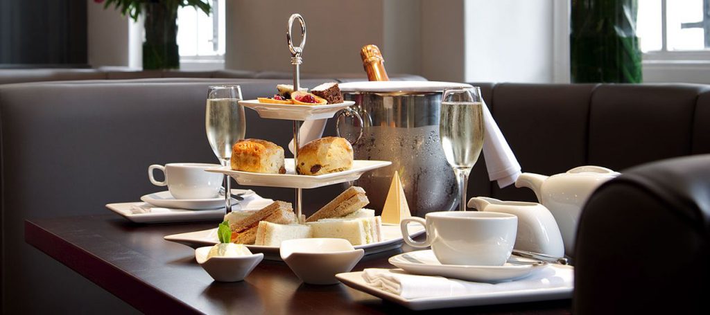 Selection of sandwiches, pastries and champagne
