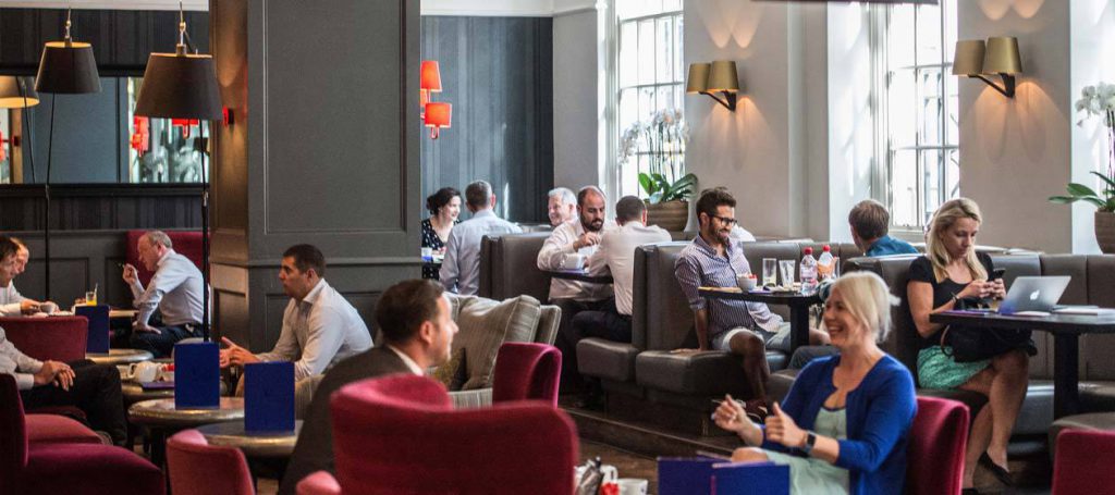 People enjoying drinks in a busy Quarter Bar and Lounge