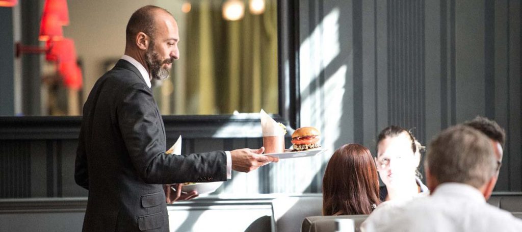 Waiter bringing some food to diners at the Quarter Bar and Lounge