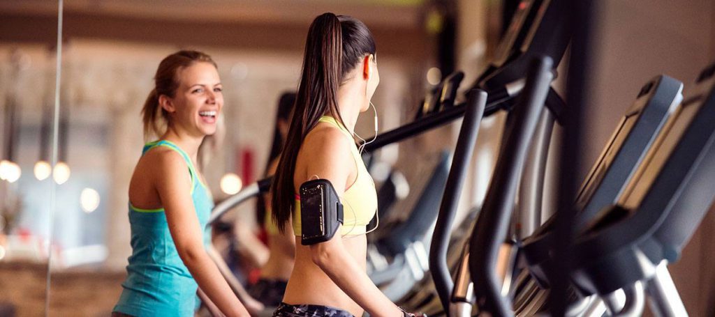 Two young women on the treadmills in the hotel gym