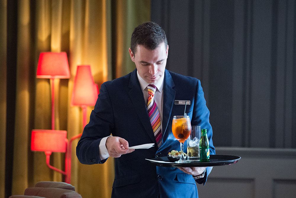 Waiter carrying a tray of drinks and aperitifs