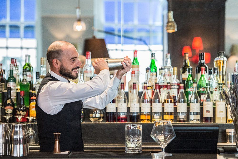 Hotel barman making cocktails